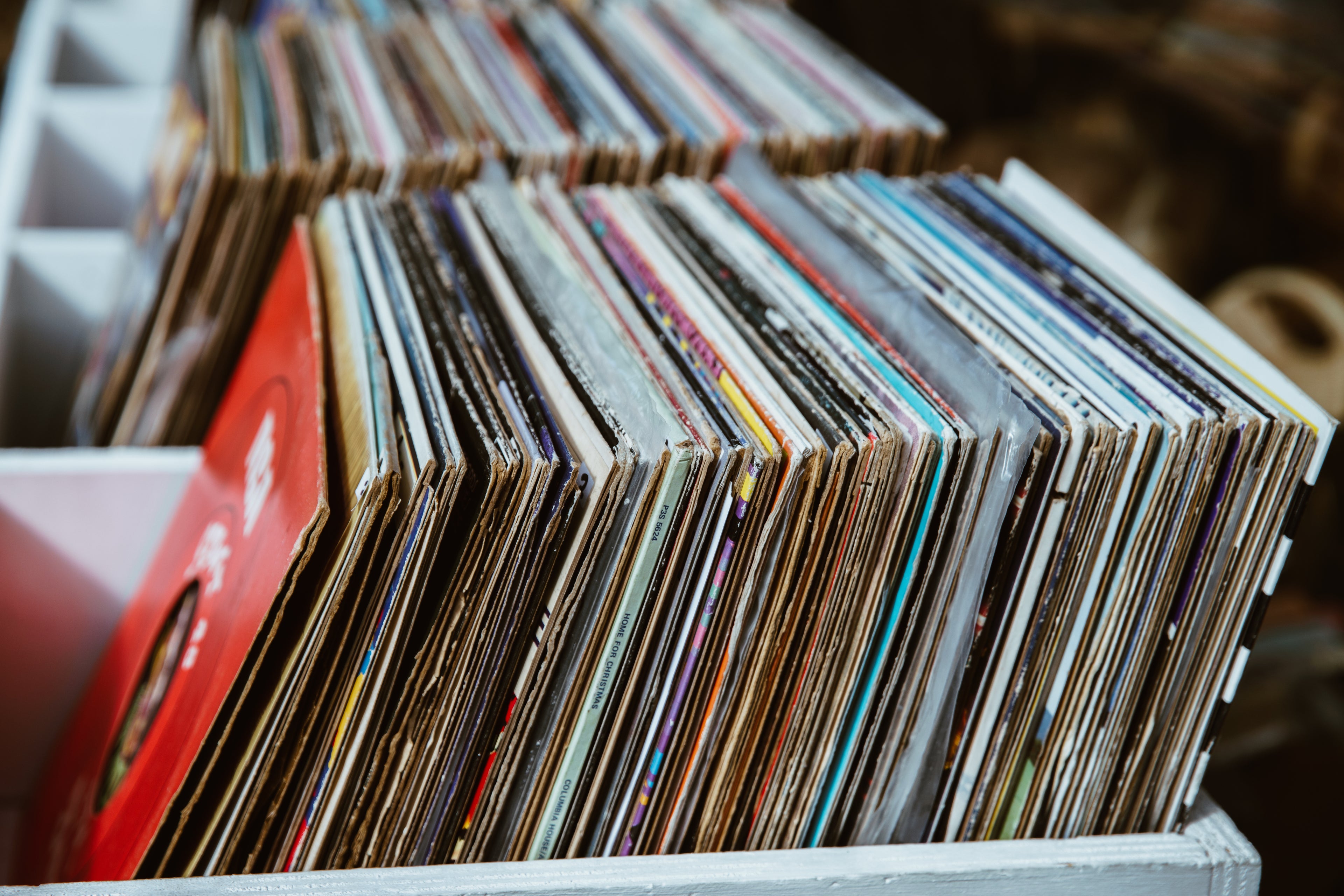 An image of a bin of vinyl records in a retail store
